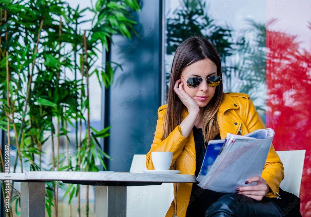 young woman sit in cafe outdoor reading magazine young woman sit in cafe outdoor reading magazine
