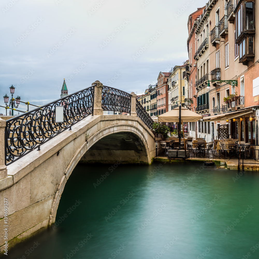 long time exposure of a typical venetian bridge over a canal, Venice, Italy, Europe