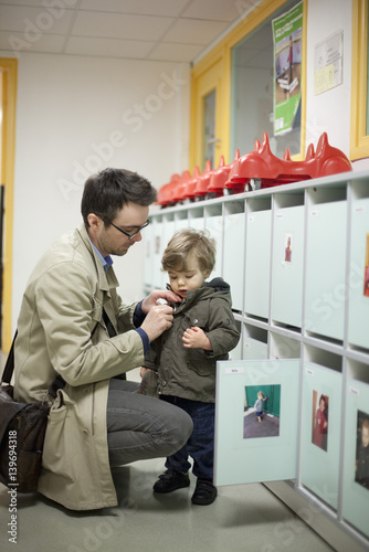 Father dropping toddler son off at preschool photo