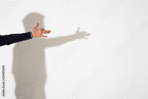 Man shows shadow of dog with fingers