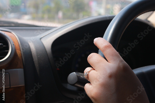 women hand driving the car