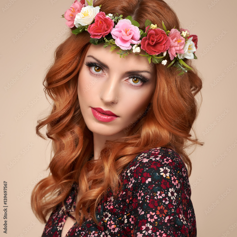Fototapeta premium Fashion Beautiful Curly Redhead Portrait in Flower Wreath. Shiny Curly flower fashion Volume Hairstyle. Happy Beauty Model Woman. Glamour Confident Sexy lady, fashion Makeup, Boho wreath, Trendy Dress