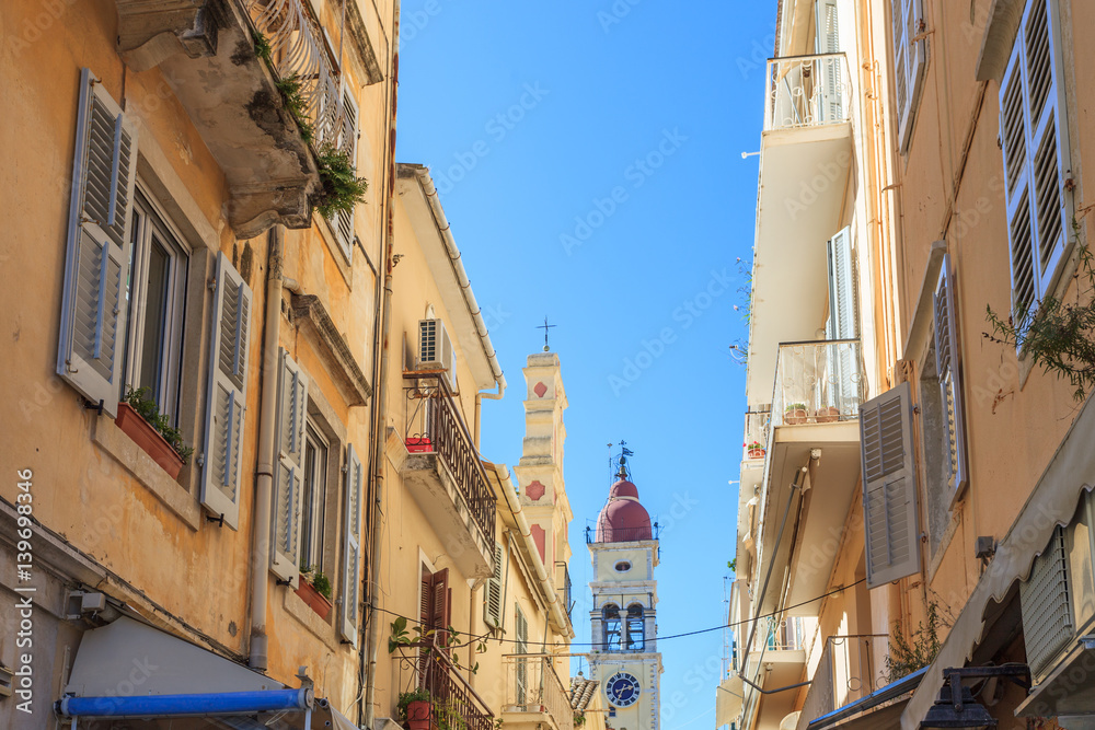 KERKYRA, CORFU, GREECE - Mart 4 2017: Tourists walking and shopping on narrow streets in the historical Kerkyra city center in Corfu near the Cathedral of St. Spyridon of Trimythous