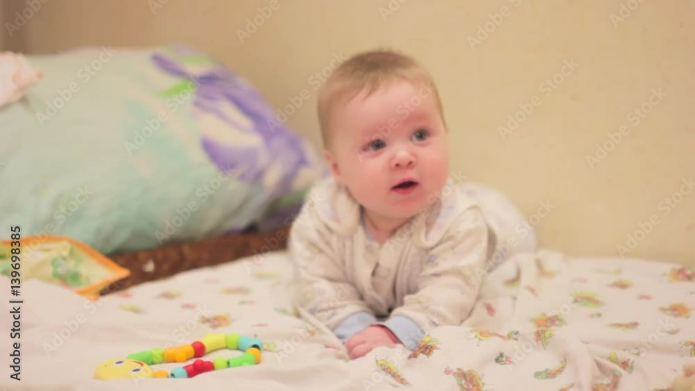 the baby is lying on the bed the baby is lying on the bed