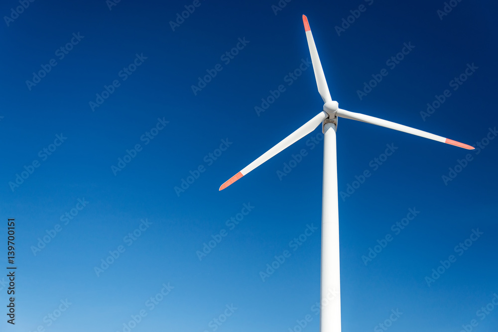 Wind turbines against a blue sky generating electricity Wind turbines against a blue sky generating electricity