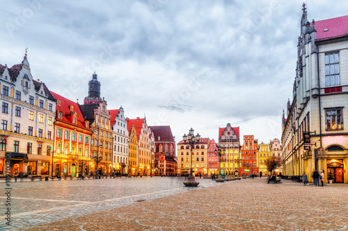 Wroclaw, polish historical city center, Poland. Market square place, old medieval buildings architecture, at dramatic sky background, evening twilight scene. Popular travel destination.