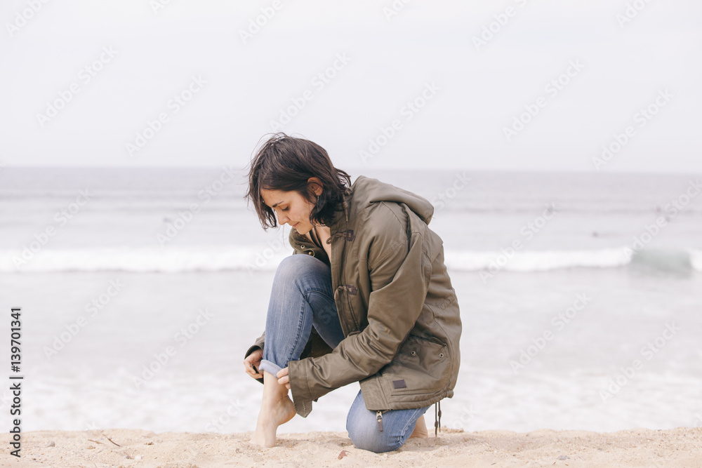 bohemian woman isolated on the beach on a cloudy day bohemian woman isolated on the beach on a cloudy day