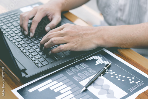 Fototapeta Naklejka Na Ścianę i Meble -  business technology concept,Business people hands use smart phone and laptop for business analyst project on table ,selective focus.