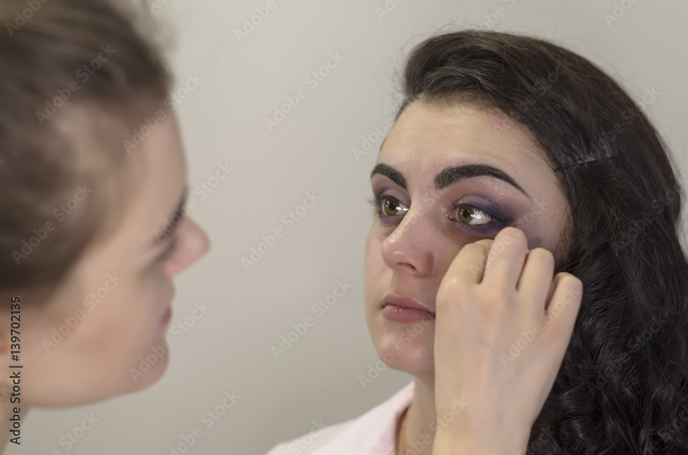 Master applies makeup on a model Master applies makeup on a model
