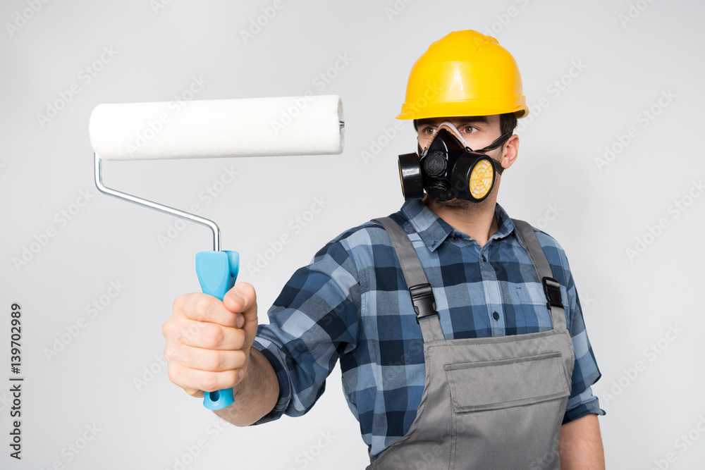 Construction worker with paint roller