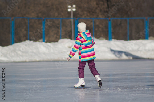 Winter sport - little girl on ice-rink - children's skating