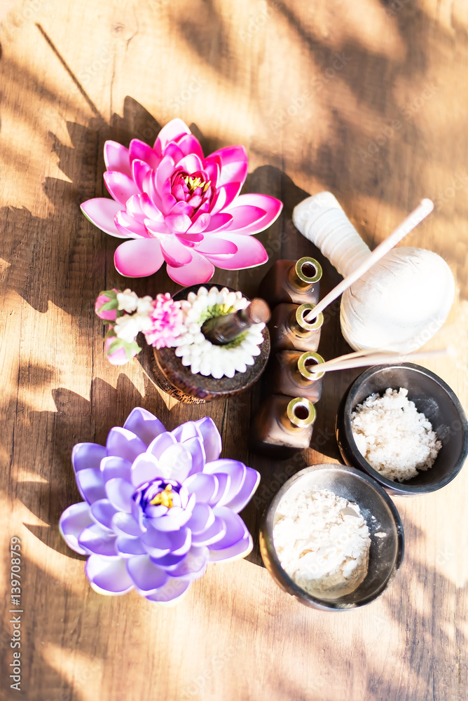 Spa still life with perfume bottle and lotus flower,Spa massage compress balls, herbal ball on the wooden with treaments spa , Thailand, select focus Spa still life with perfume bottle and lotus flower,Spa massage compress balls, herbal ball on the wooden with treaments spa , Thailand, select focus