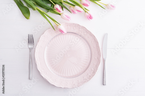Top view of pink plate and tulips above