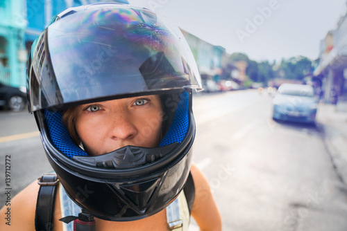 Photos Portrait of a girl in a motorcycle helmet in the street