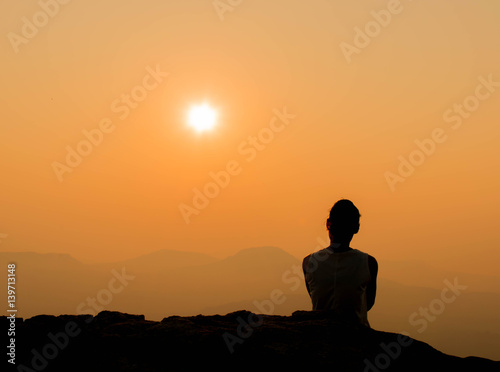 woman is looking beautiful sunrise with mountain view