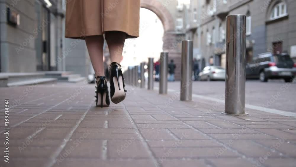 Woman wearing black high heels shoes walking away Woman wearing black high heels shoes walking away