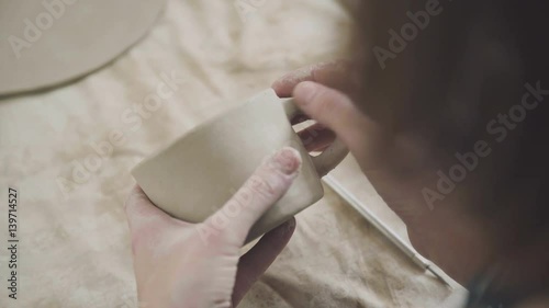 Wallpaper Mural Pottery handmade: a mug of clay. The process of creating pottery: a woman potter molds clay and makes a stylish dishes. Ceramics, pottery, handmade. Woman engaged in ceramics. Torontodigital.ca