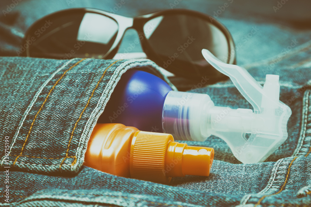 Sunscreen cosmetic products in jeans pocket Sunscreen cosmetic products in jeans pocket
