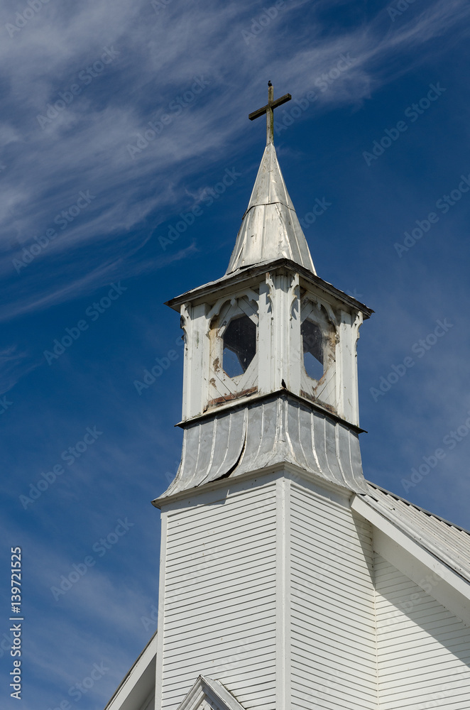 Fototapeta premium Old white church steeple and blue skies