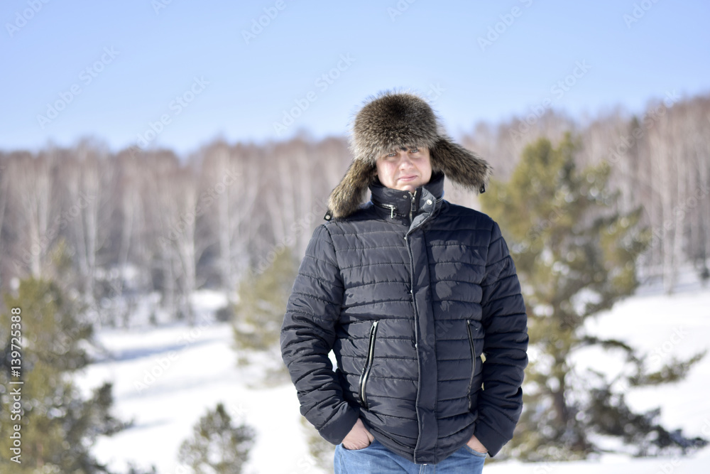 A man wearing a fur hat in the winter A man wearing a fur hat in the winter