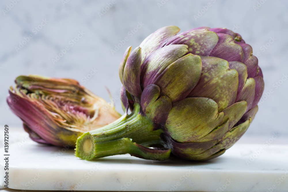 Fototapeta premium Fresh big Romanesco artichokes green-purple flower heads ready to cook