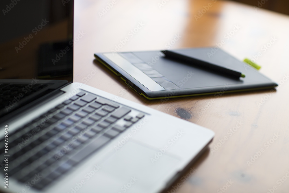 Laptop and graphic tablet on wood table. Laptop and graphic tablet on wood table.