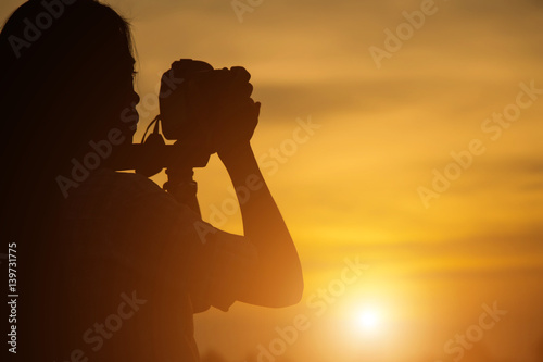 Women Nature photographer with digital camera on the mountain