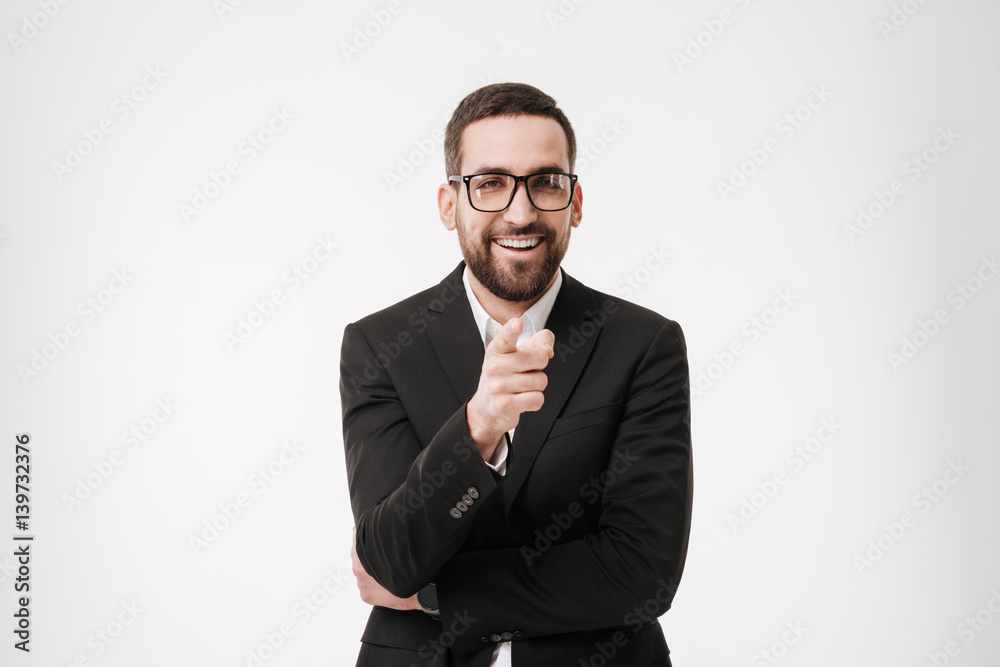 Young bearded businessman pointing to camera. Young bearded businessman pointing to camera.