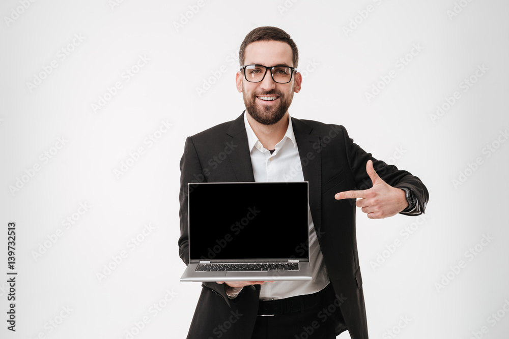 Happy businessman showing display of laptop computer and pointing. Happy businessman showing display of laptop computer and pointing.