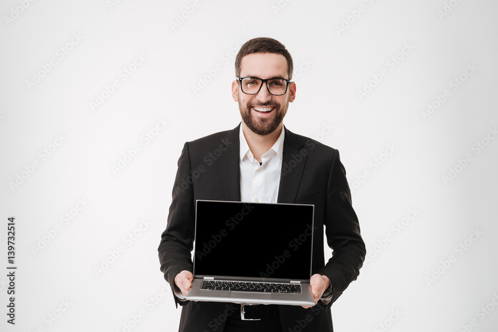 Cheerful businessman showing display of laptop computer.