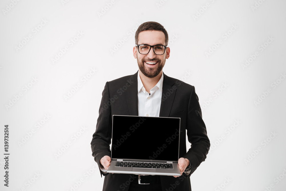 Cheerful businessman showing display of laptop computer. Cheerful businessman showing display of laptop computer.