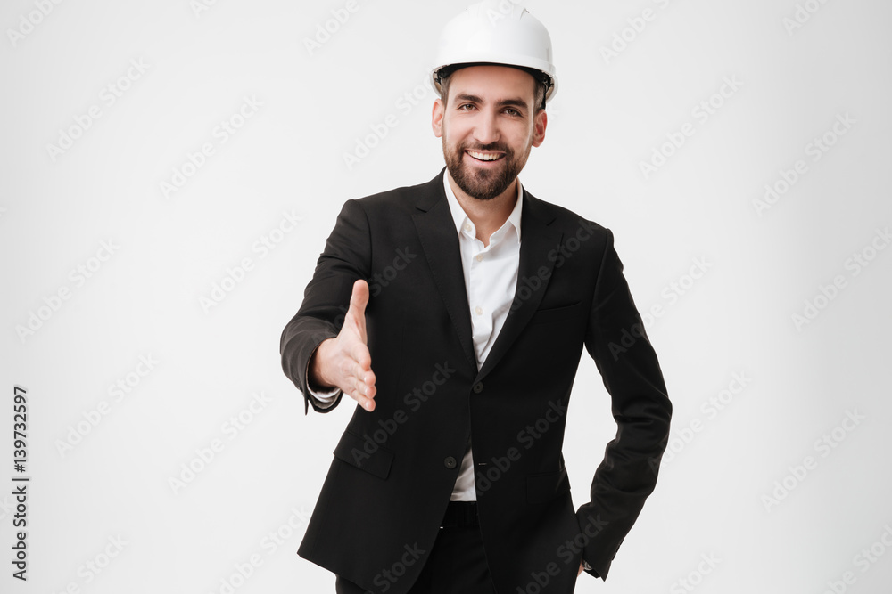 Cheerful architect wearing helmet gives a hand to camera. Cheerful architect wearing helmet gives a hand to camera.