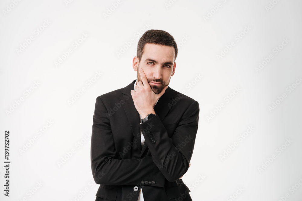 Serious young businessman posing over white background. Serious young businessman posing over white background.