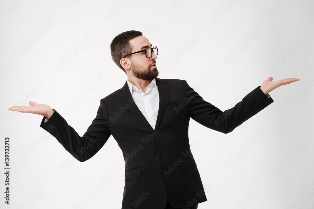 Handsome young bearded businessman holding copyspace