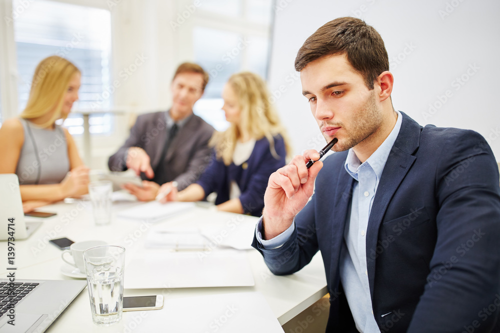 Young businessman looking pensive Young businessman looking pensive