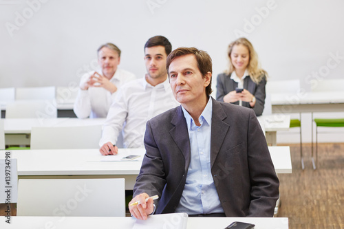 Business people in a seminar listening to a spreech photo