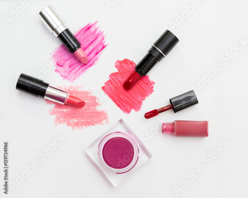 Makeup blush and lipsticks on white background