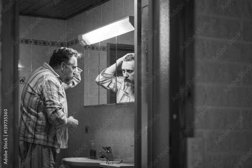 Middle-aged man at bathroom in the morning Middle-aged man at bathroom in the morning