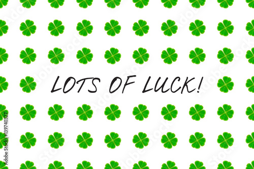 Saint Patrick s Day greeting card with green mosaic clover leaves and text on white background. Inscription - LOTS OF LUCK  vector illustration.