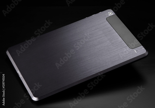 Tablet black silver metal on black background product back flat shadow