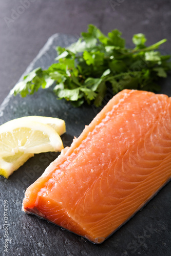 Raw salmon fillet on slate plate
