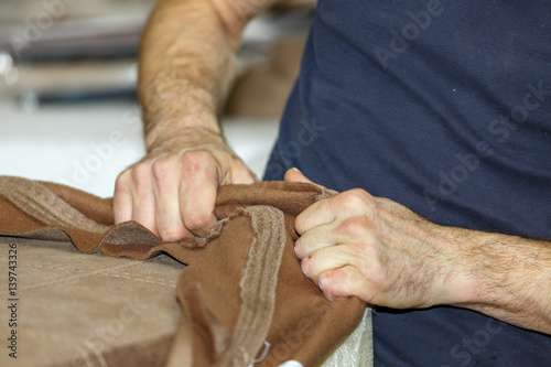  Hands of a man who works with cloth