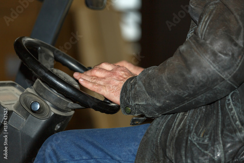 Men's hands on the the steering wheel