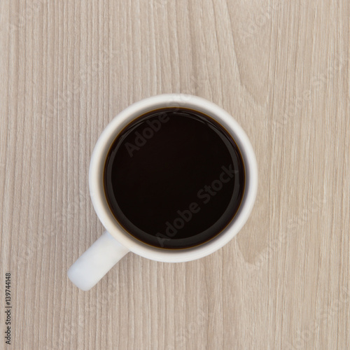 top view of a cup of coffee on a wooden table