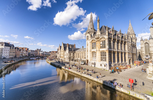 GENT, BELGIUM - MARCH 2015: Tourists visit ancient medieval city. Gent attracts more than 1 million people annually photo