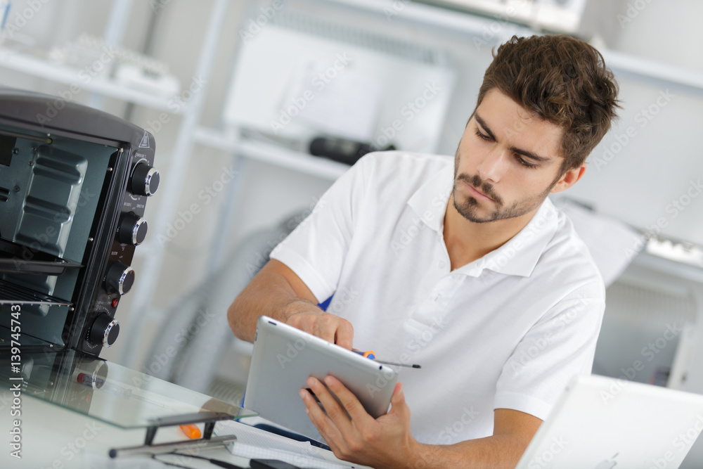 attractive repairman concentrated at work