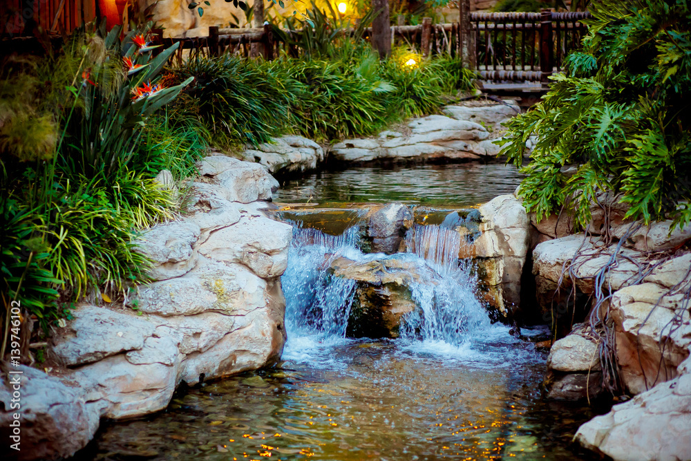 Fototapeta premium Tropical waterfall in the PortAventura park in Spain, La Pineda.