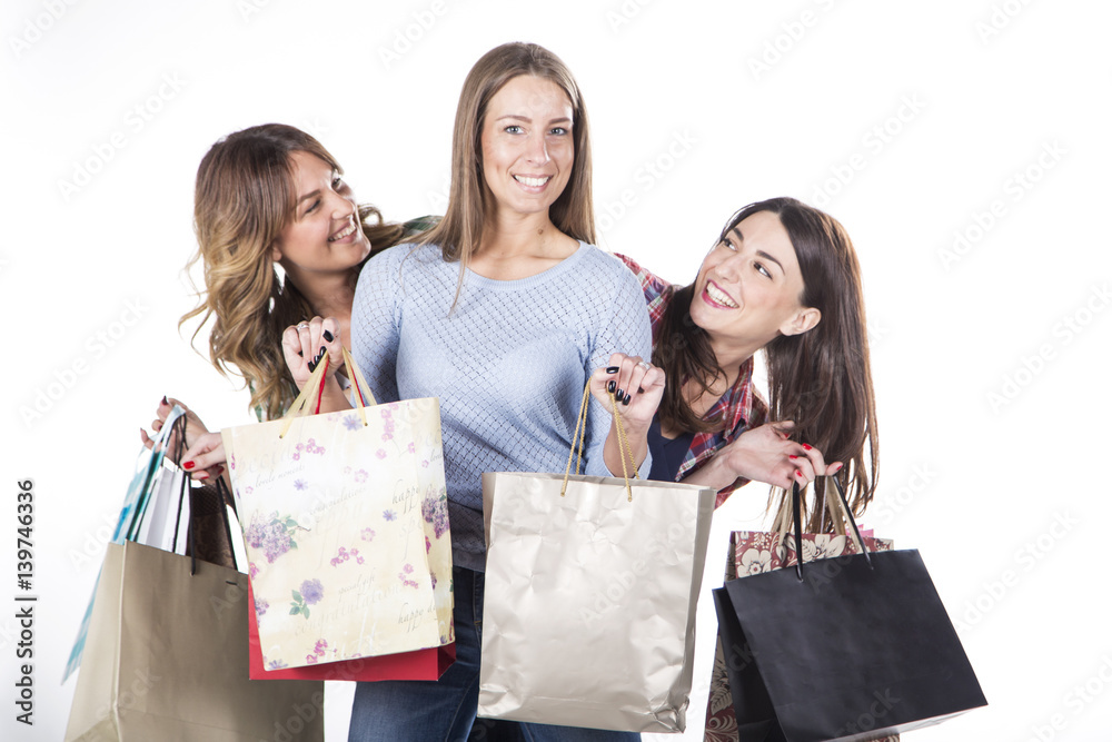 Group of happy women smiling with shopping bags isolated on white background. Group of happy women smiling with shopping bags isolated on white background.