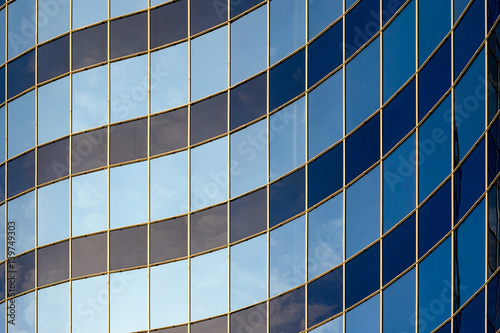 Curved glass facade of modern building. Abstract background