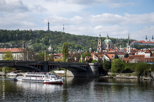 View of the Church and bridge at the Vltava River with boat Prague Czech Republic
